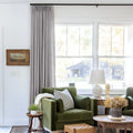 Rock Grey Liz linen curtains shown closer beside a sunlit window with smooth vertical folds
