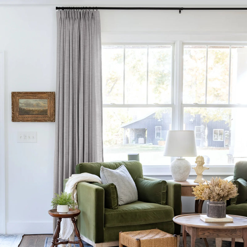 Rock Grey Liz linen curtains shown closer beside a sunlit window with smooth vertical folds
