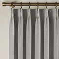 Rock Grey Liz linen curtains viewed at an angle in a softly styled room with natural daylight