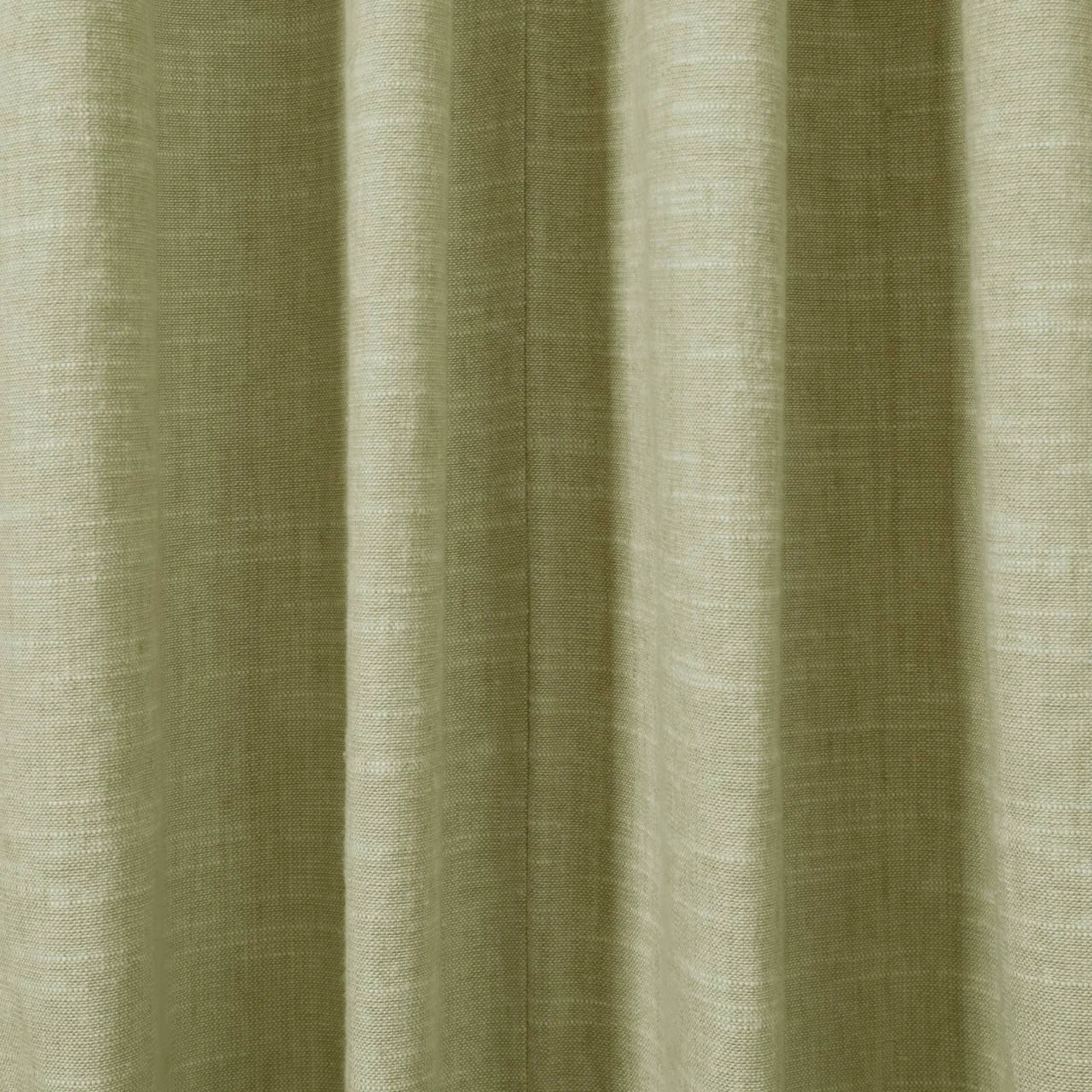 Close-up photograph of a textured sage green fabric curtain featuring prominent vertical pleats and a visible woven linen-like texture