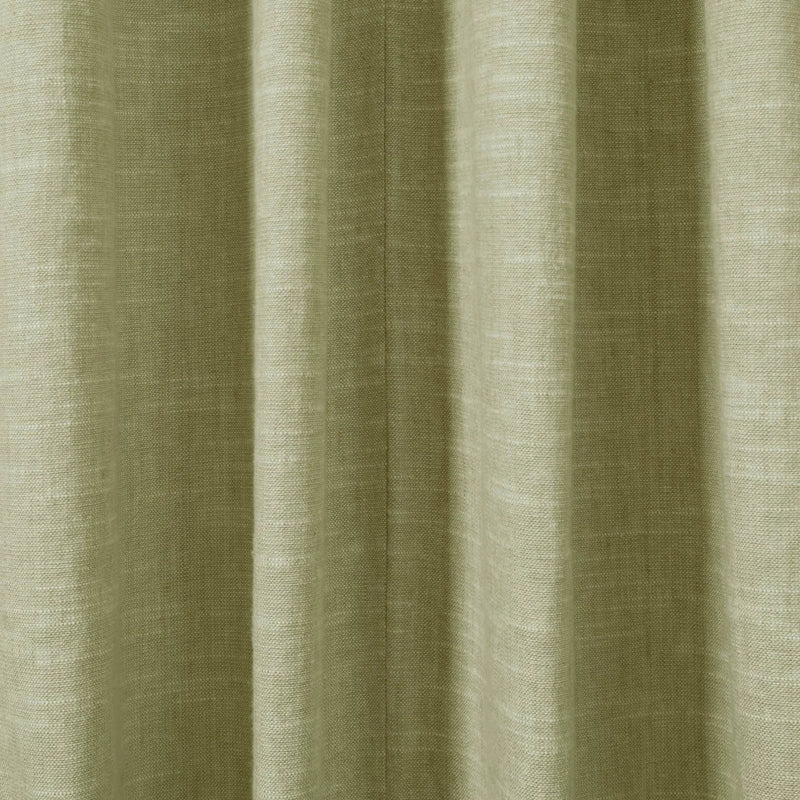 Close-up photograph of a textured sage green fabric curtain featuring prominent vertical pleats and a visible woven linen-like texture