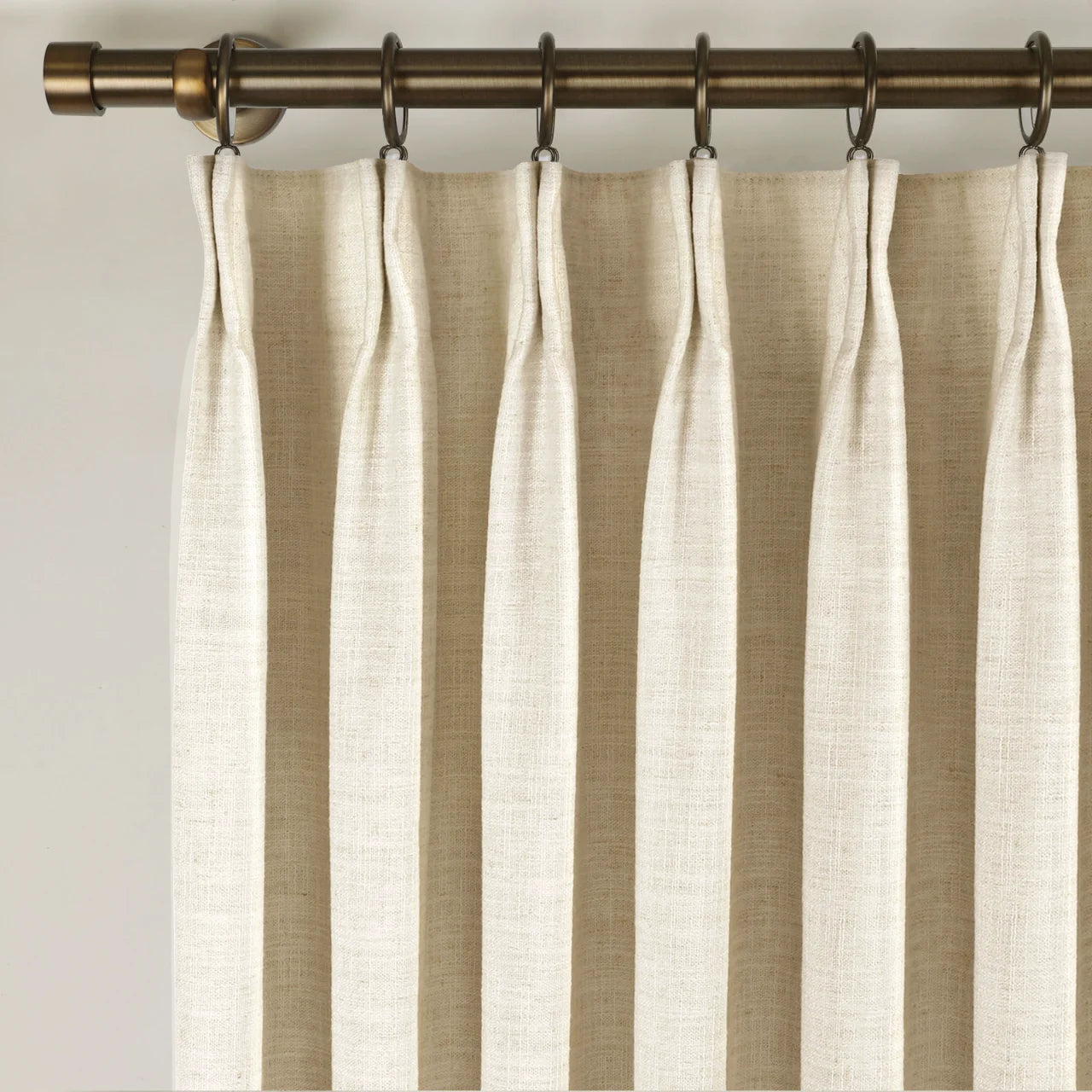 Sand Beige Liz Linen Pleated Curtains triple pinch pleat heading on a bronze curtain rod