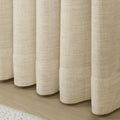 Sand Beige Liz Linen Pleated Curtains rounded curtain hems above a pale wood floor