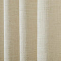 Close-up of oatmeal colored fabric with a coarse woven texture draped in soft vertical folds