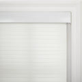 White zebra roller Blind featuring alternating translucent and opaque horizontal bands installed within an ornate white window casing with a visible control cord