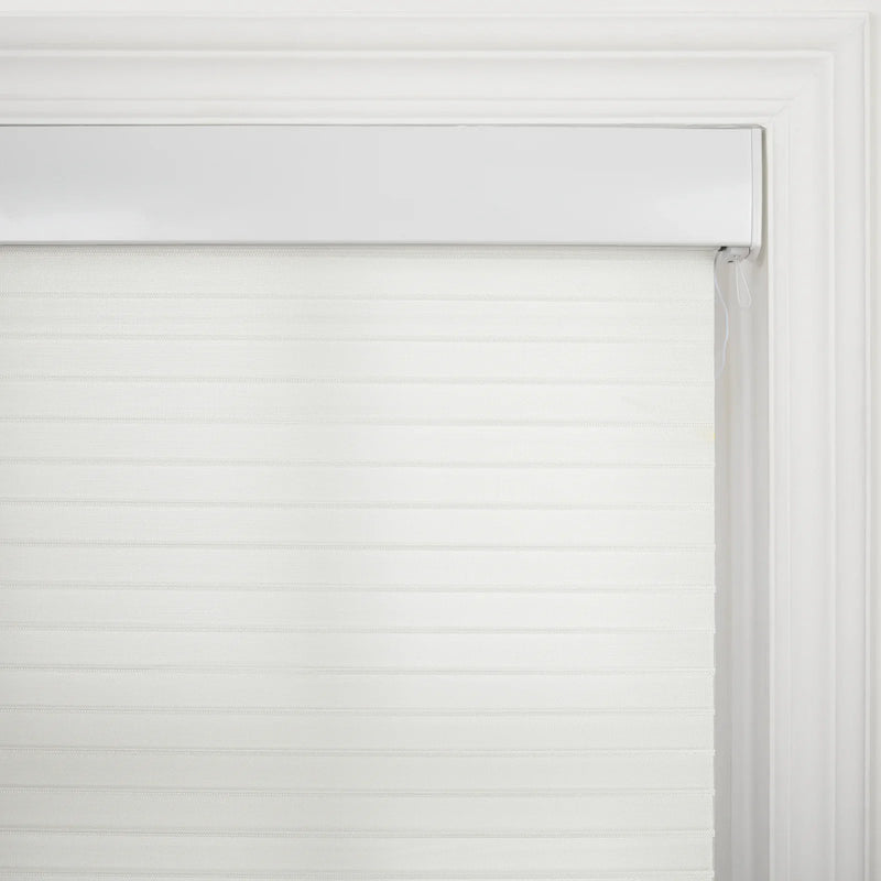White zebra roller Blind featuring alternating translucent and opaque horizontal bands installed within an ornate white window casing with a visible control cord