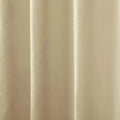 Photograph of a cream-colored fabric curtain with vertical pleats creating gentle shadows and highlights showcasing a subtle woven texture