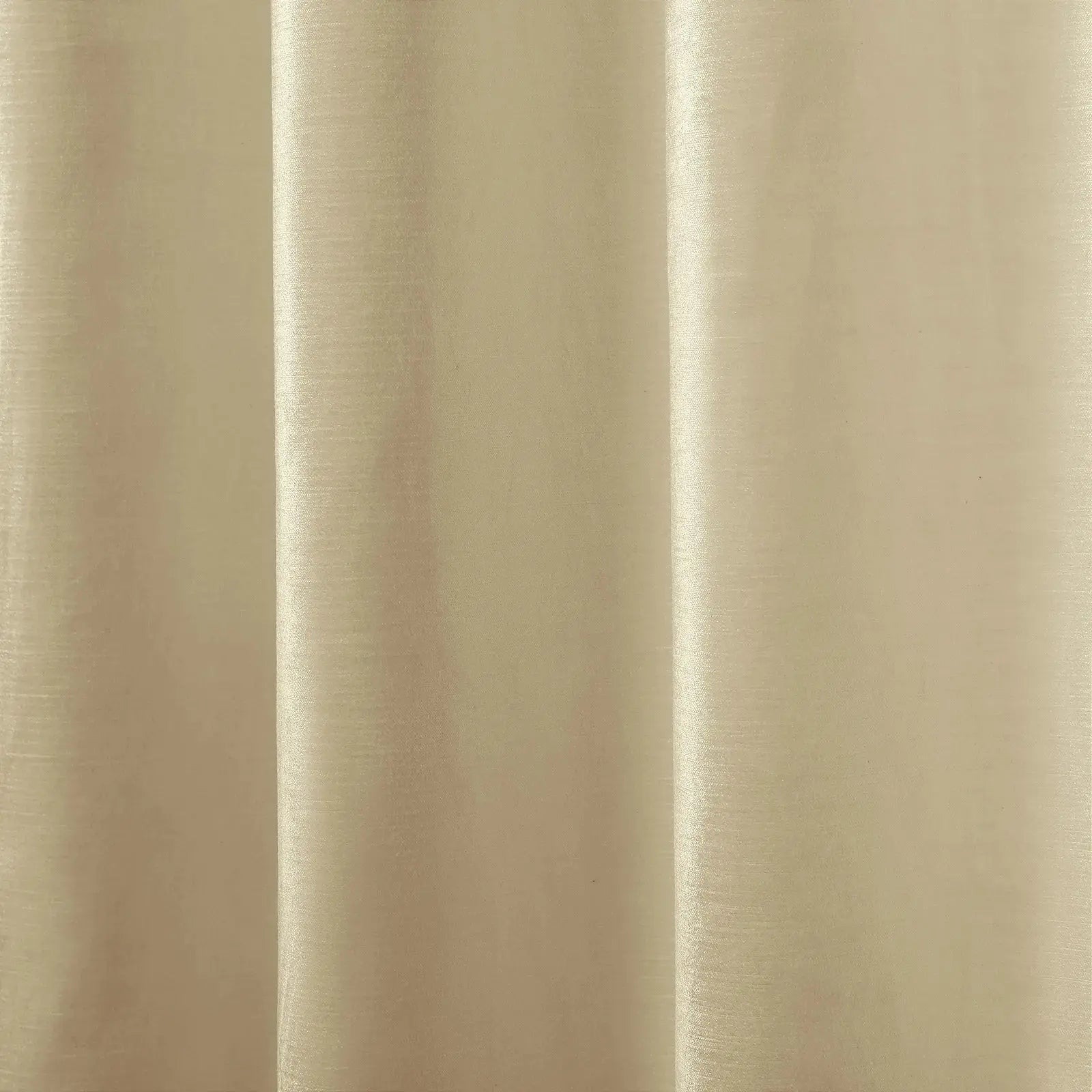 Photograph of a cream-colored fabric curtain with vertical pleats creating gentle shadows and highlights showcasing a subtle woven texture