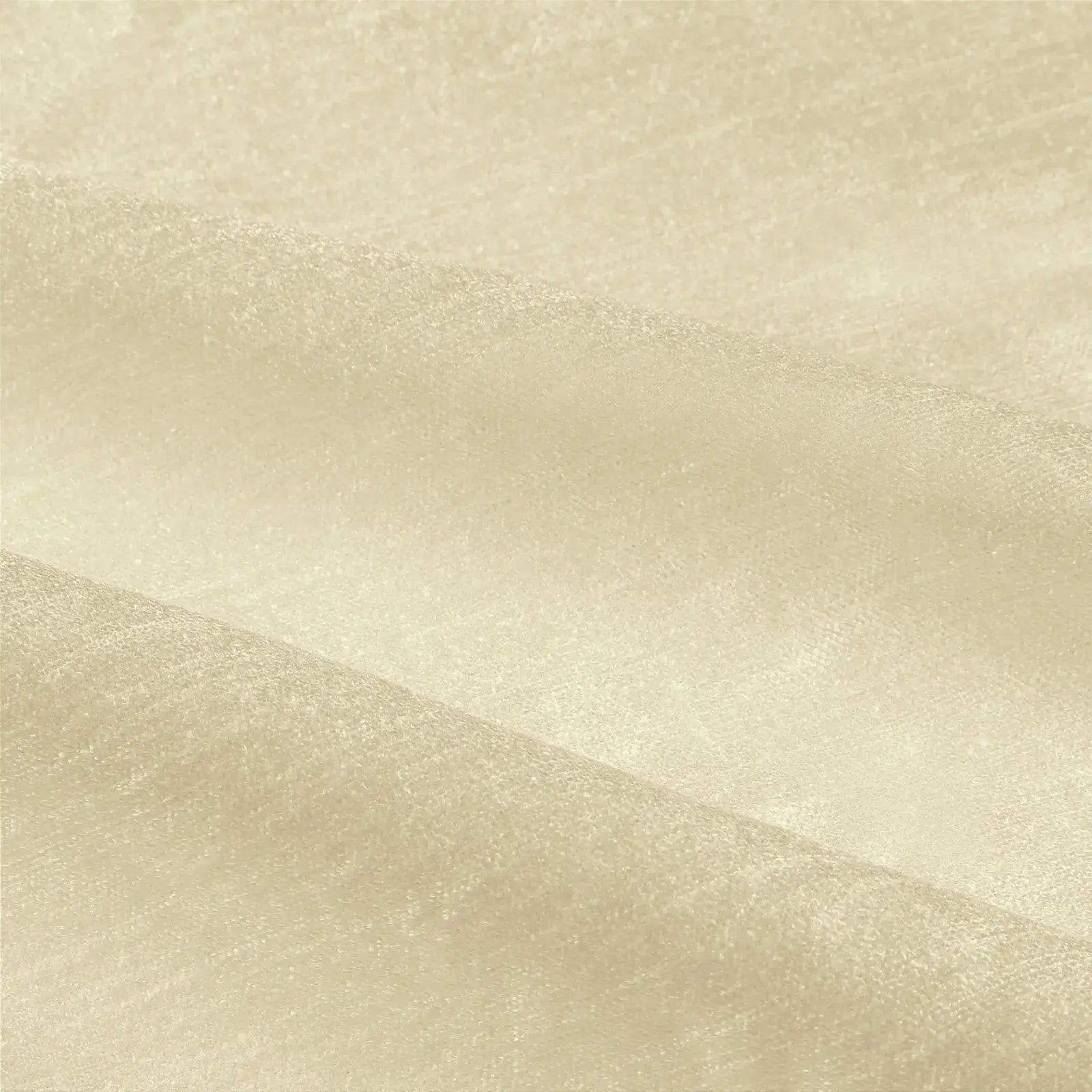Detailed close-up of light cream fabric with a subtle shimmering texture and elegant gentle folds