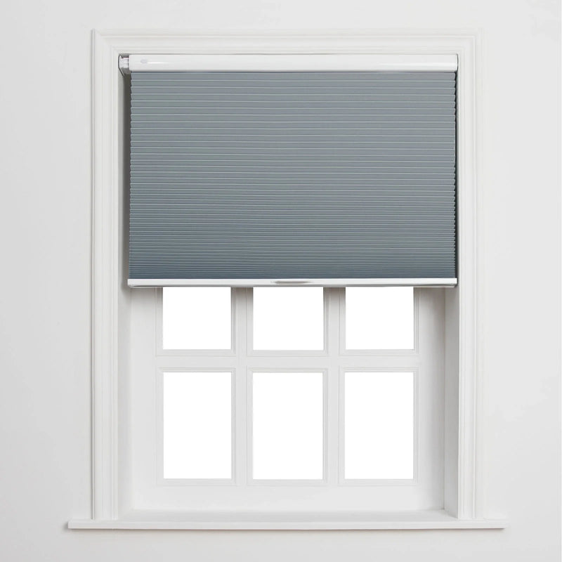 A white-framed window featuring a partially lowered grey cellular Blind above six blank white panes