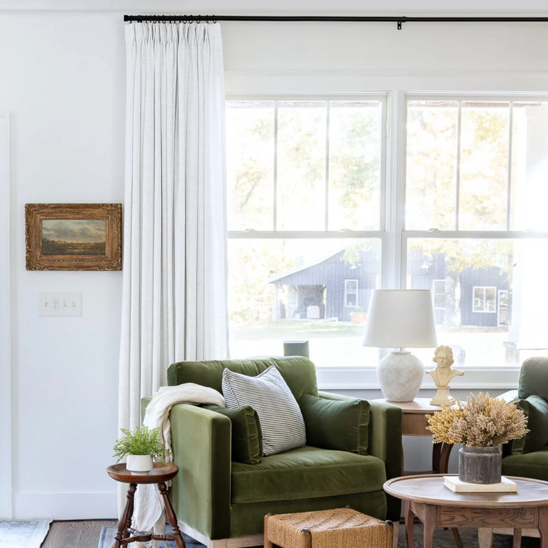 Snow White Liz Linen Pleated Curtains beside a green sofa and dried-flower coffee-table arrangement