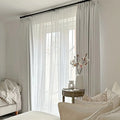 Snow White Liz Linen Pleated Curtains softly filtering daylight in a white reading nook