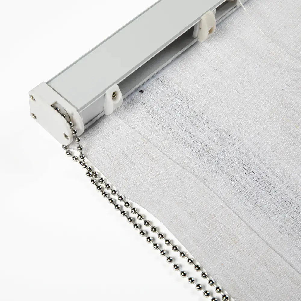 Close-up detail of a roller blind system showing a silver metal track, white sheer fabric with a subtle texture, and a shiny double silver ball chain pull cord attached to a white plastic mechanism