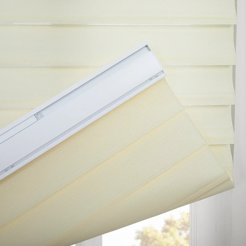 Layered cream and sheer fabric zebra Blind with a white headrail partially open revealing blurred outdoor trees