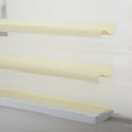 A modern zebra roller Blind featuring alternating sheer white and opaque beige horizontal stripes, a subtle woven texture, and softly curved fabric layers near the bottom