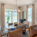 Tapioca Liz Linen Pleated Curtains in a sunlit dining room with leather chairs and glass pendant lights