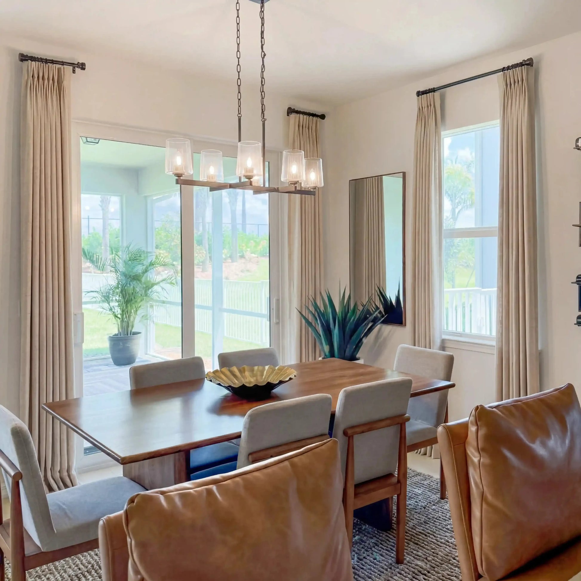 Tapioca Liz Linen Pleated Curtains in a sunlit dining room with leather chairs and glass pendant lights