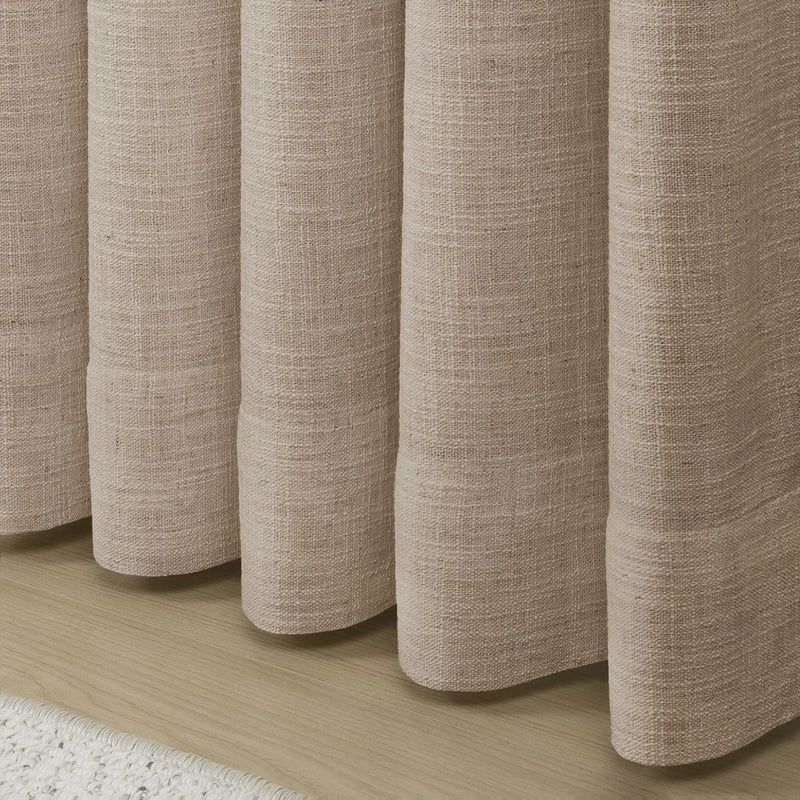 Tapioca Liz Linen Pleated Curtains rounded curtain hems above a pale wood floor