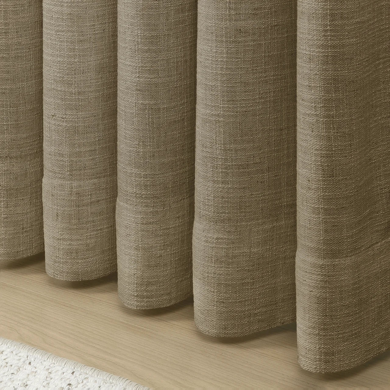 Taupe Grey Liz Linen Pleated Curtains rounded curtain hems above a pale wood floor