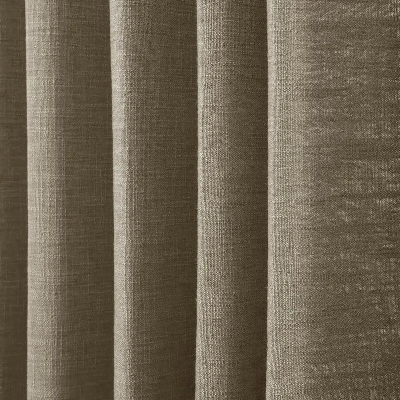 Close-up of a warm taupe textured fabric showing distinct vertical folds and a visible slub weave