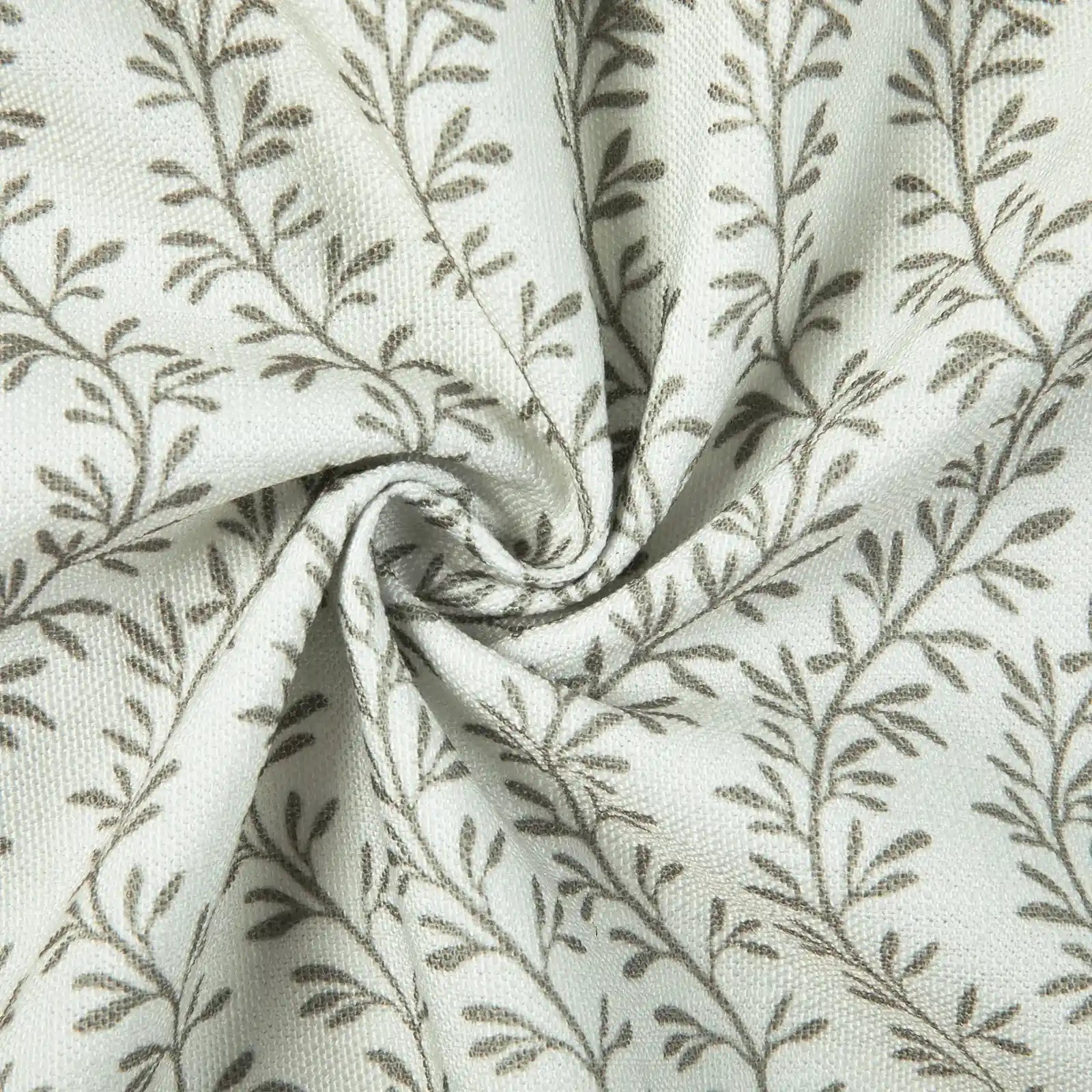 Textile featuring a white woven background with a repeating pattern of slender grey stylized leaves and branches, showing soft ripples and a central spiral fold highlighting its texture