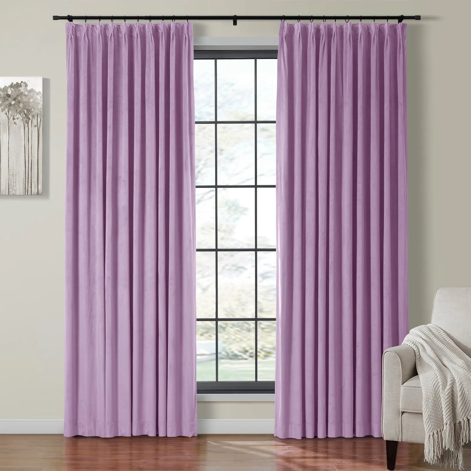 Velvet lilac pinch pleat curtains frame a large grid window, revealing a beige armchair with a white fringed throw and modern gray tree artwork on a light wall