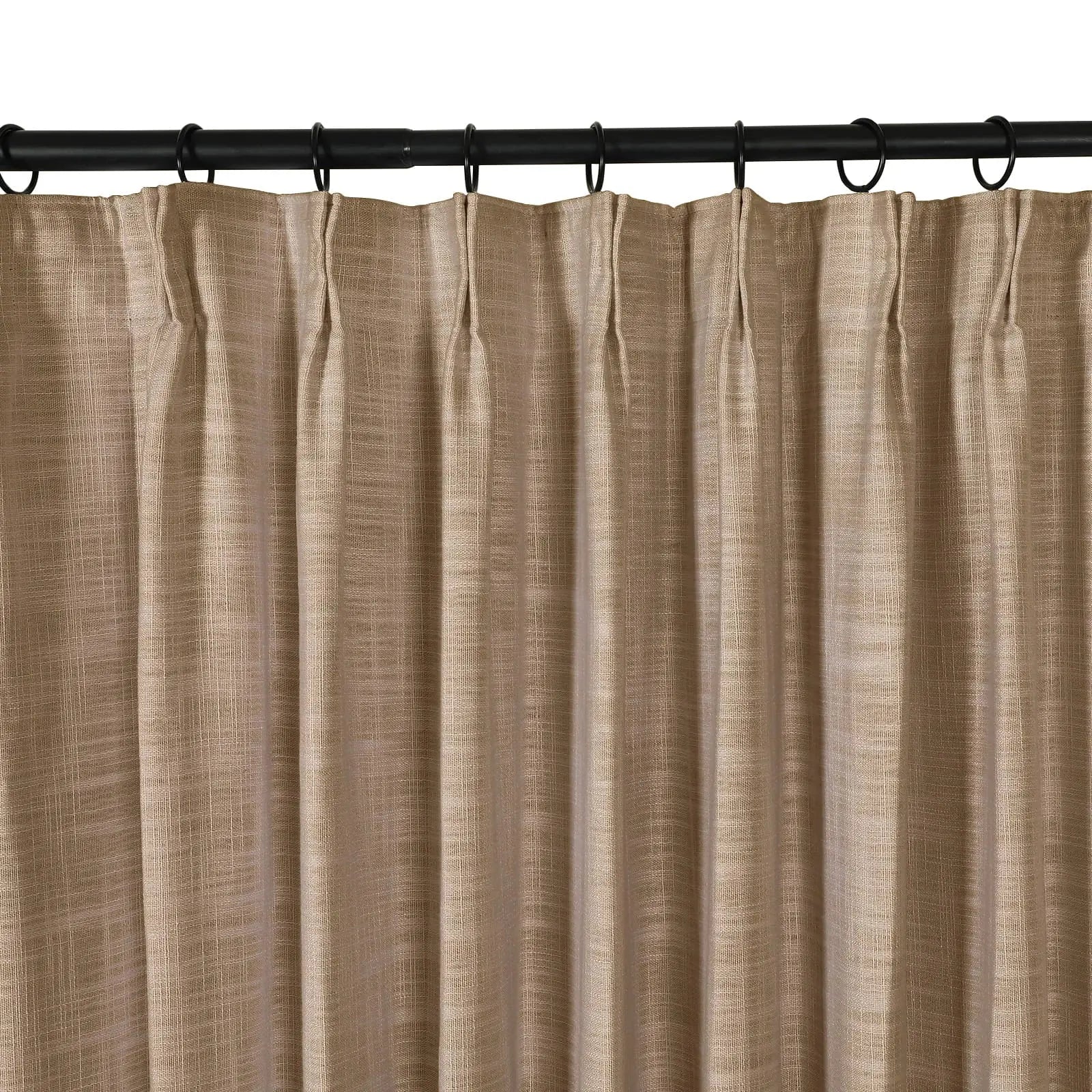 Photograph of a tan textured linen-look pleated curtain hanging from a black rod with rings