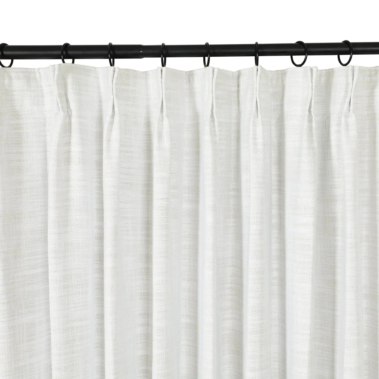 White textured linen blend curtain with subtle pleats hanging from black metal rings on a sleek black curtain rod