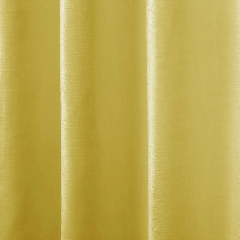 Photograph of shimmering chartreuse fabric featuring prominent vertical folds and a subtle horizontal weave