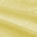 Photograph of a light yellow fabric with a subtle sheen, fine crinkled texture, and soft diagonal folds