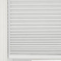 Photograph of light gray pleated cellular window Blinds covering a window, showcasing their textured fabric and horizontal folds