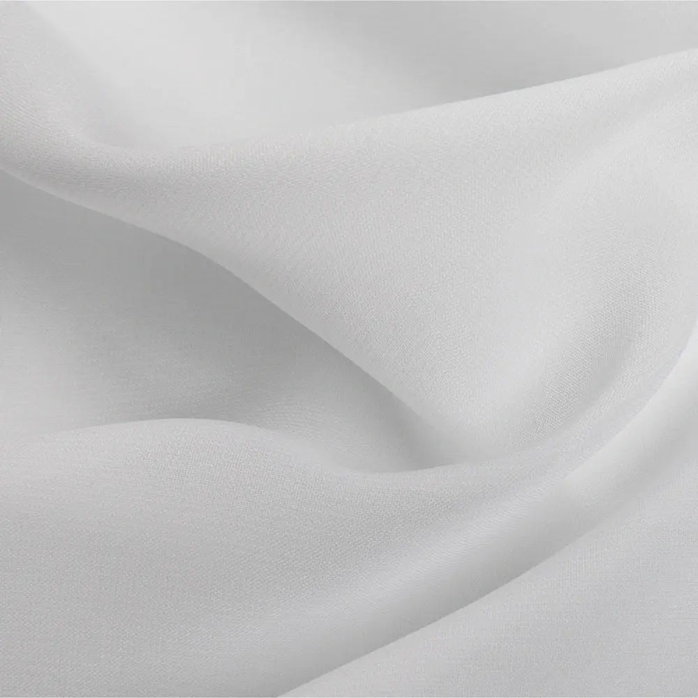Photograph of elegant white fabric draped in soft flowing folds with subtle shadows highlighting its delicate texture