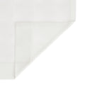 Fine woven white fabric featuring a subtle grid pattern with a neat triangular fold in the bottom right