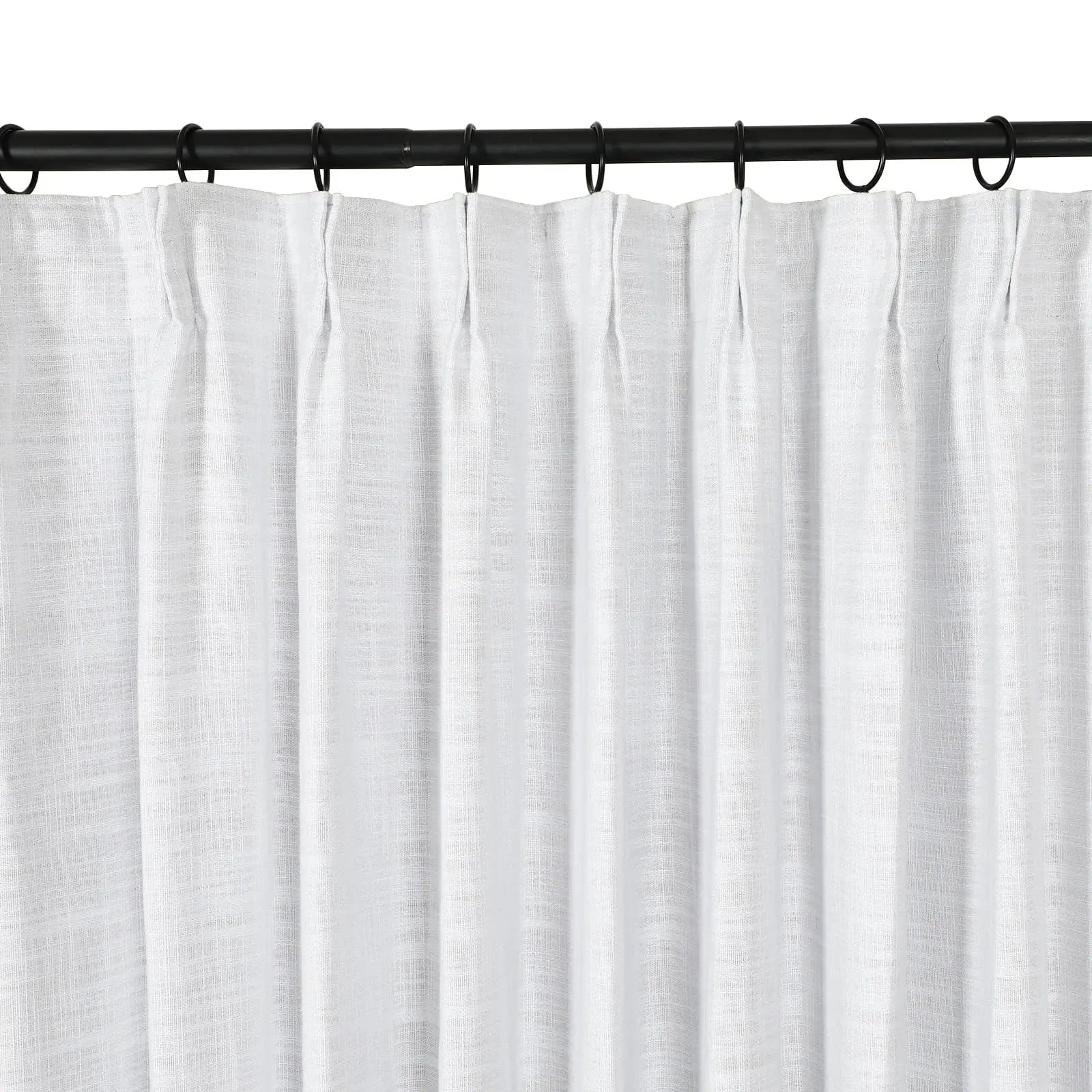 Photograph of white subtly textured curtains with a pleated header hanging on a black metal rod with rings