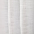 Photograph of white textured linen fabric showing distinct woven threads and soft vertical drapes creating subtle shadows