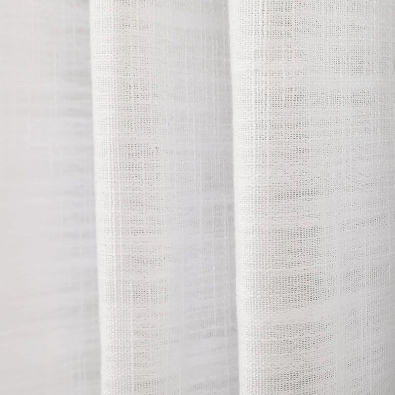 Photograph of white textured linen fabric showing distinct woven threads and soft vertical drapes creating subtle shadows
