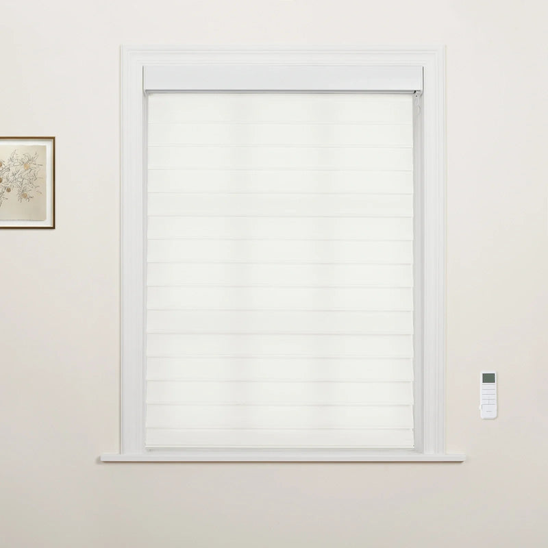 A minimalist room featuring a window with modern white layered zebra Blinds, an elegant white trimmed frame, a small framed botanical print, and a wall-mounted smart remote control