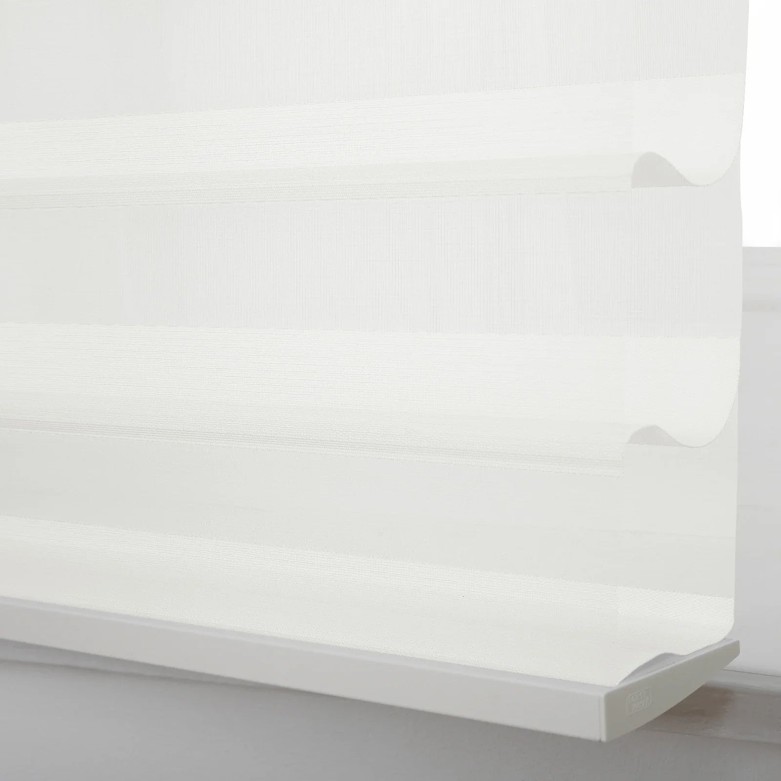 White zebra window Blind featuring alternating sheer and opaque horizontal woven stripes, partially lowered to reveal its unique dual-layer design and a sleek bottom rail